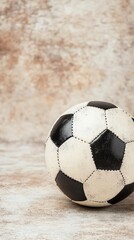 Wall Mural - Classic black and white soccer ball on a textured background ready for play or display