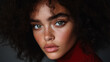 © Anastasiia - close up portrait of a woman with curly wavy brown hair in red turtleneck set against grey background