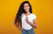© Prostock-studio - Portrait of excited hungry young woman holding fork in her mouth, biting and dreaming about delicious healthy food, choosing something to eat posing looking aside isolated on yellow orange studio wall