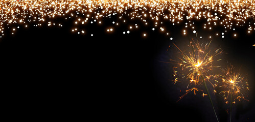 Wall Mural - Christmas sparkler lights on dark sky background.