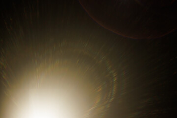 Fototapete - Easy to add lens flare effects for overlay designs or screen blending mode to make high-quality images. Abstract sun burst, digital flare, iridescent glare over black background.