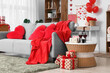 © Pixel-Shot - Interior of living room decorated for Valentine's Day celebration with table and sofa with heart-shaped cushions