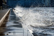 © gehapromo - Water from waves splashes over Cologne's Rhine boulevard during high water levels on the Rhine in January 2024
