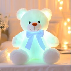 Wall Mural - Glowing light-up plush teddy bear toy with blue bow.