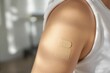 © Derek Brumby - Close-Up of a Band-Aid on a Bare Arm in a Sunlit Room