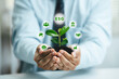 © Deemerwha studio - Business hands holding green plant tree with ESG icon concept in the hand for environmental, social, and governance in sustainable and ethical business. Green investment concept