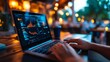 © nuryadin - Night Stock Market Analysis on Laptop at a Cafe