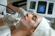 © ty - cosmetologist using radiofrequency microneedling device while performing beauty skincare