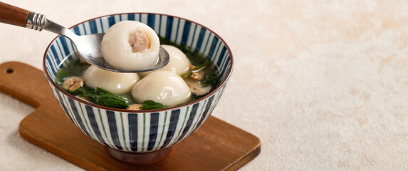 Wall Mural - Eating big tangyuan yuanxiao with savory soup in Taiwan.