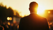 © Taras Vykhopen - Silhouette of a politician at an outdoor rally during sunset creates a dramatic atmosphere