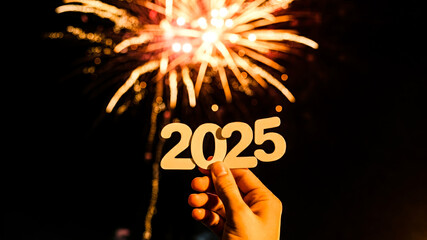 Sticker - hand holding 2025 for new years celebration with firework in background