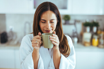 Wall Mural - Woman Enjoying Morning Coffee in Cozy Kitchen Setting