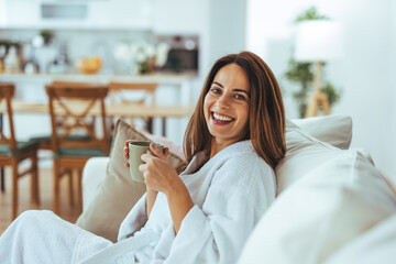 Wall Mural - Relaxed Woman Enjoying Coffee On Comfortable Sofa at Home