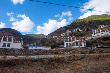 Wall Mural - Views of Tibetan houses, green field and mountains along the road from Shangri La to Yading, Sichuan 