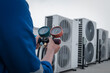 © Nonthanat - Technician is checking air conditioner,measuring equipment for filling air conditioners.