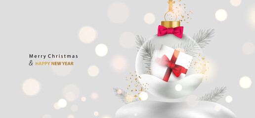 Wall Mural - Merry Christmas background. Glass transparent ball with gift box and snow inside. Holiday card with glossy snowball and silver branches on bokeh light. Vector x-mas design.