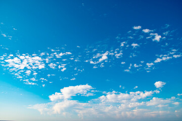 Wall Mural - Background with calm blue sky and white cumulus clouds. Relaxing backdrop on the theme of weather and climate.