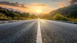 © Anas - Asphalt Road Leading to a Mountainous Sunset