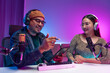 © BJ Day Stock - Two young asian streamer host making live podcast with condenser microphone and tablet at broadcast home studio. Content creator and social media influencer creating digital content.