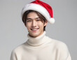 © anmitsu - Portrait of a young handsome male model wearing a Santa Claus hat and a turtleneck sweater. Christmas image.サンタクロースの帽子をかぶってタートルネックのセーターを着た若いイケメン男性モデルのポートレート。クリスマスのイメージ。