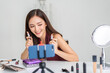 © Art_Photo - Woman asian beauty blogger live streaming discussing lipsticks skincare and cosmetics, beauty vlogger reviewing makeup products, influencer content creation, makeup tutorial, online beauty community