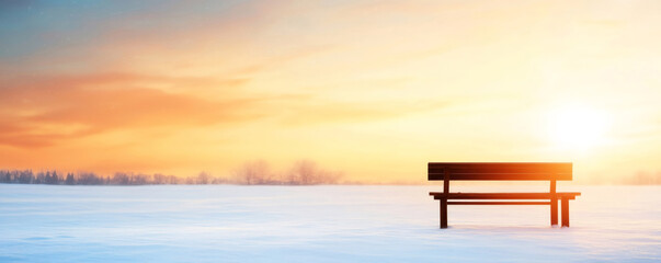 Wall Mural - snow-covered field with an empty bench basking in the warm glow of the setting sun, creating a tranq