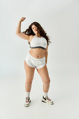 Young plus size woman showcases trendy underwear with confidence, embracing her beauty and style.