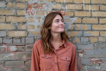 Wall Mural - Portrait of a blissful caucasian woman in her 20s sporting a breathable hiking shirt isolated in vintage brick wall