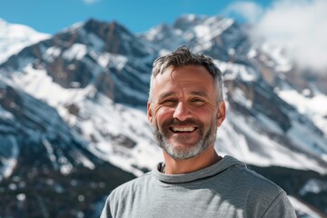 Wall Mural - Portrait of a glad man in his 40s donning a trendy cropped top isolated on snowy mountain range