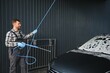© Serhii - Car Wash Specialist Using Pressure Washer to Rinse a car