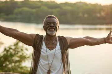 Wall Mural - Portrait of a joyful afro-american man in his 50s dressed in a breathable mesh vest while standing against serene lakeside view