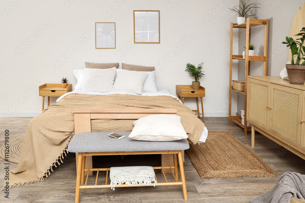 Interior of bedroom with soft bench, shelf unit and plants