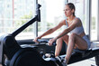 © ty - Sporty female using a rowing machine during cross fit training. Female athlete exercising intensely in the gym. High quality photo