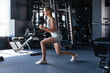 © ty - Athletic woman with kettlebell doing a lunges. Strength and motivation.