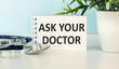 © Pawel - Ask your Doctor text message isolated on hospital clinic office background.