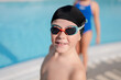 © ADDICTIVE STOCK - Child in swim gear enjoying a sunny day at an outdoor pool