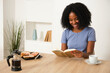 © ADDICTIVE STOCK - Young African American Woman Enjoying a Relaxing Moment at Home