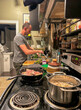 © tessy morelli/Stocksy - UGC man cooking at home