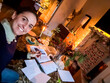 © tessy morelli/Stocksy - UGC POV selfie writing Christmas letters at home