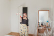 © Melika Tursic/Stocksy - Woman protecting room for painting