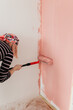 © Melika Tursic/Stocksy - Paint roller on a pink wall