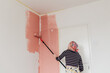 © Melika Tursic/Stocksy - Woman painting wall at home, first move