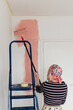 © Melika Tursic/Stocksy - Woman painting wall at home, first move