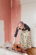 © Melika Tursic/Stocksy - Woman mixing colors for painting wall at home
