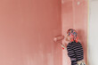 © Melika Tursic/Stocksy - Woman painting wall at home