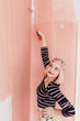 © Melika Tursic/Stocksy - portrait of a woman posing with pink brush