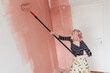 © Melika Tursic/Stocksy - Woman painting wall at home