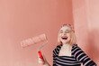 © Melika Tursic/Stocksy - portrait of a smiling woman posing with pink brush