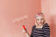 © Melika Tursic/Stocksy - portrait of a smiling woman posing with pink brush