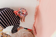 © Melika Tursic/Stocksy - Woman painting wall at home, first move